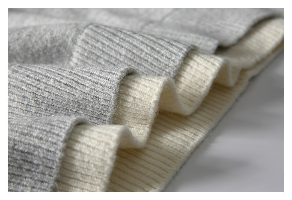 Close-up of gray and cream ribbed knit cuffs or edges layered together.