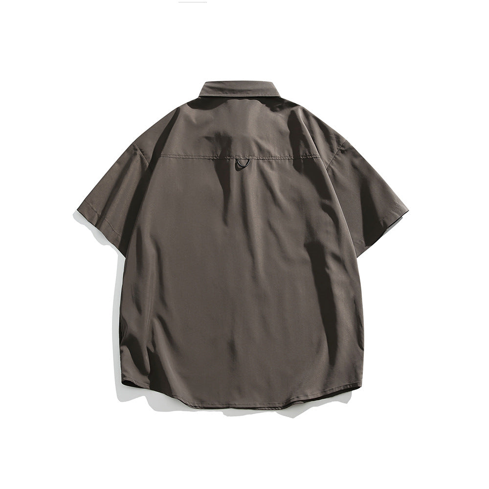 Back view of a taupe-brown short-sleeve button-up shirt with a spread collar and curved hem.