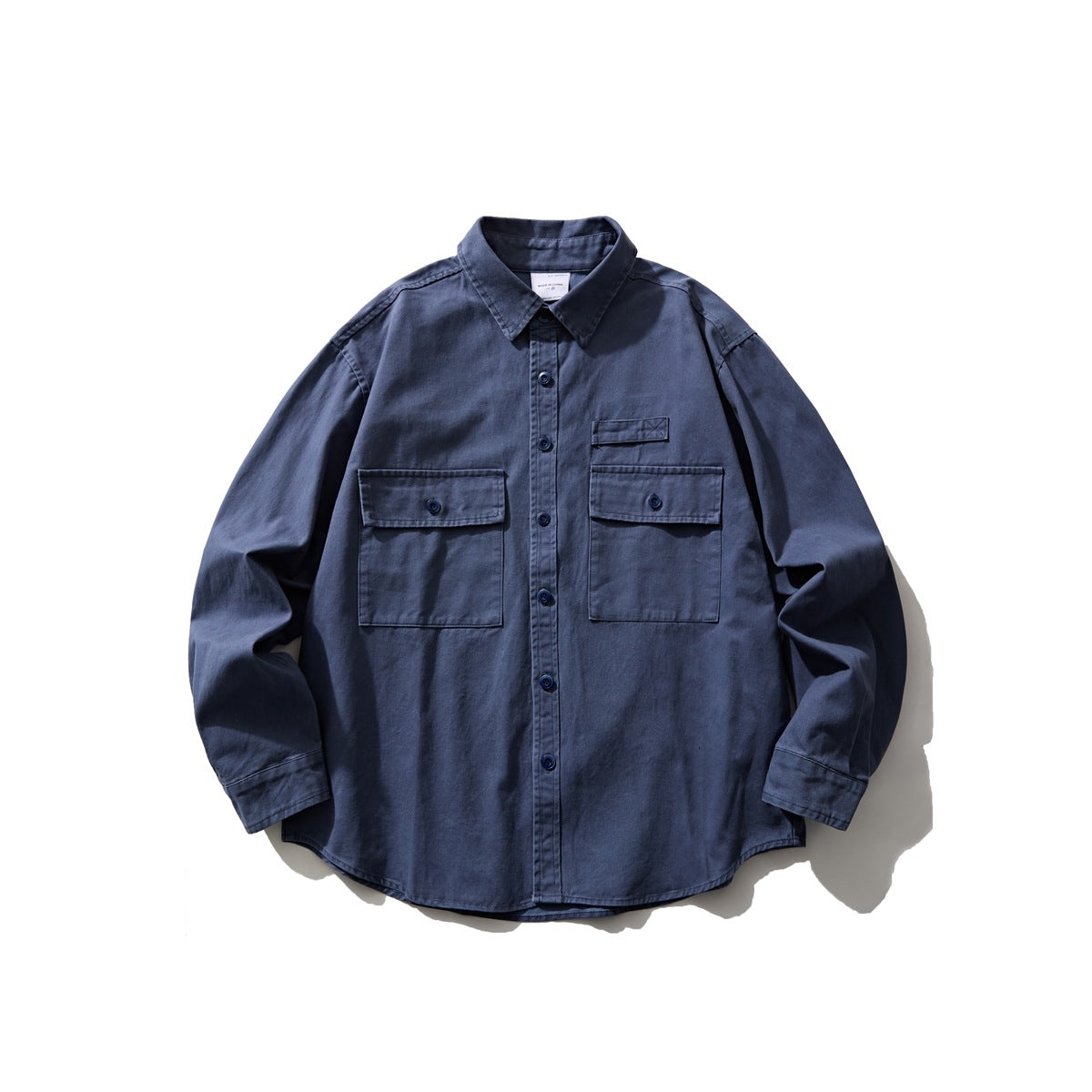 Dusty blue long-sleeve button-front shirt with two flap chest pockets, flat lay front view