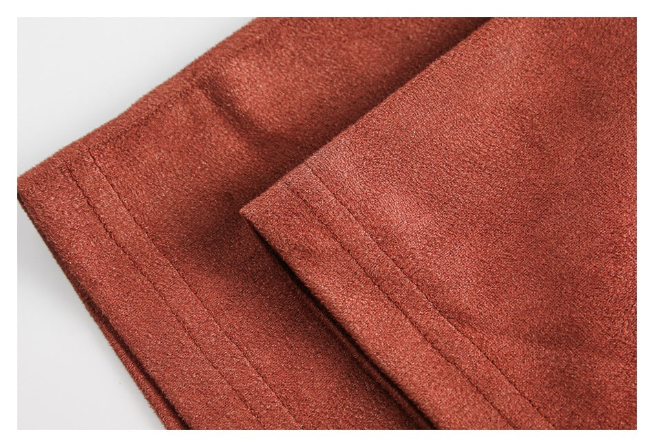 Close-up of a rust-colored garment hem with double rows of stitching.