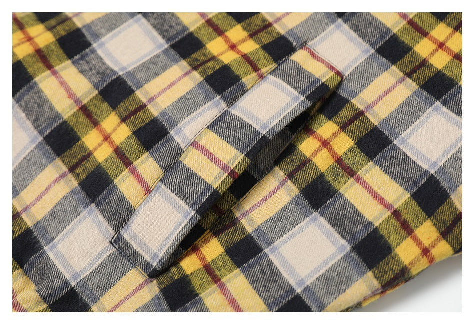 Close-up of a welt pocket on the jacket's multicolor plaid fabric.