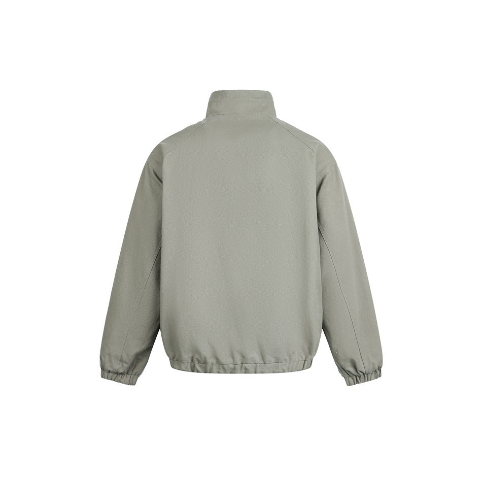 Back view of a sage-gray jacket with a stand collar, raglan sleeves, and elasticated cuffs and hem.