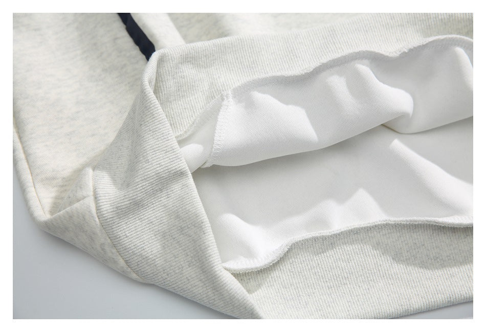 Close-up of the sweatshirt's turned hem, showing the ribbed outer band and white inner surface.