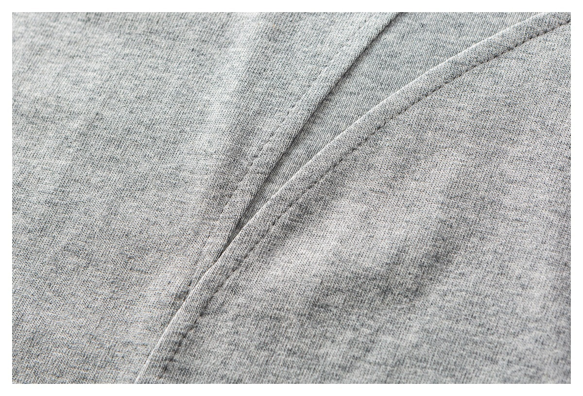 Close-up of heather gray knit fabric showing a curved double-stitched seam.