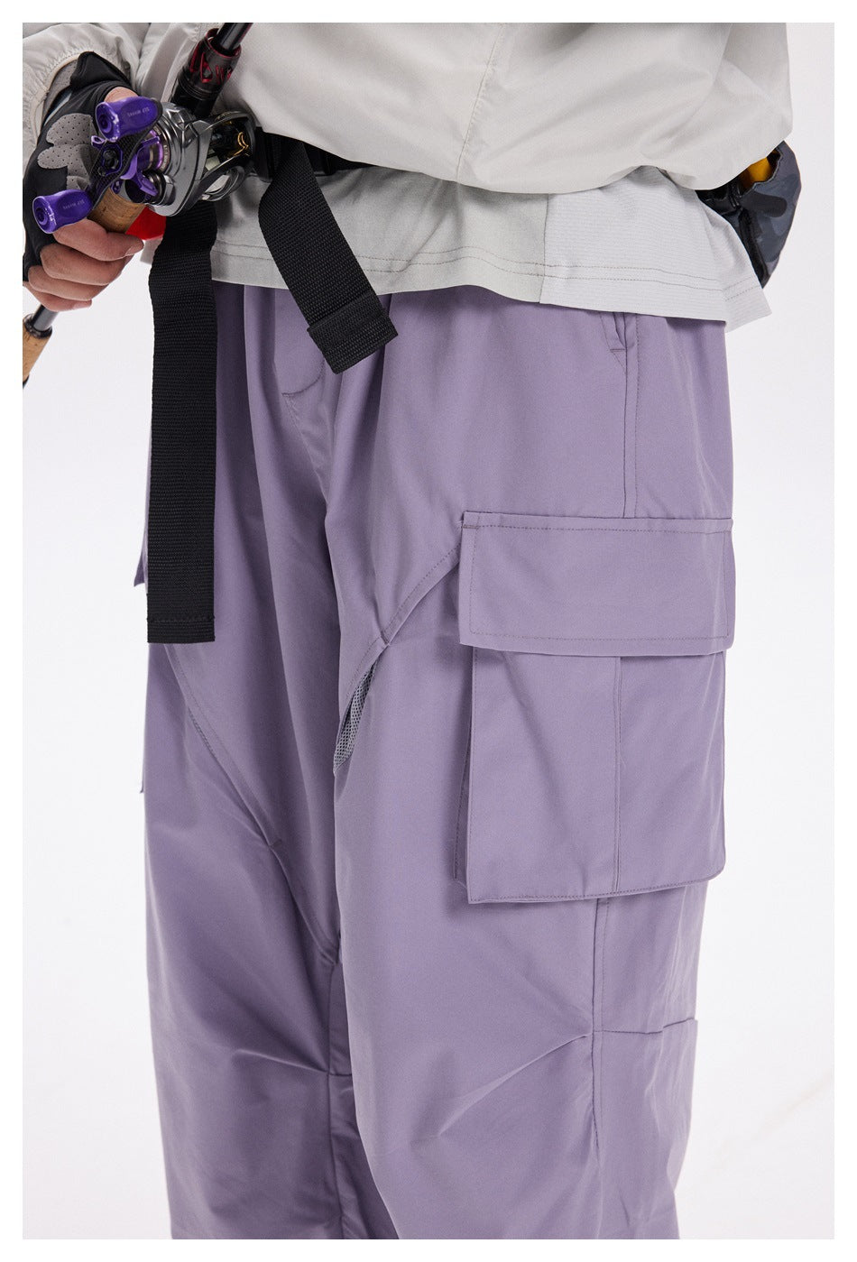 Close-up of lavender cargo pants showing the large layered thigh pocket and angular seam detailing.