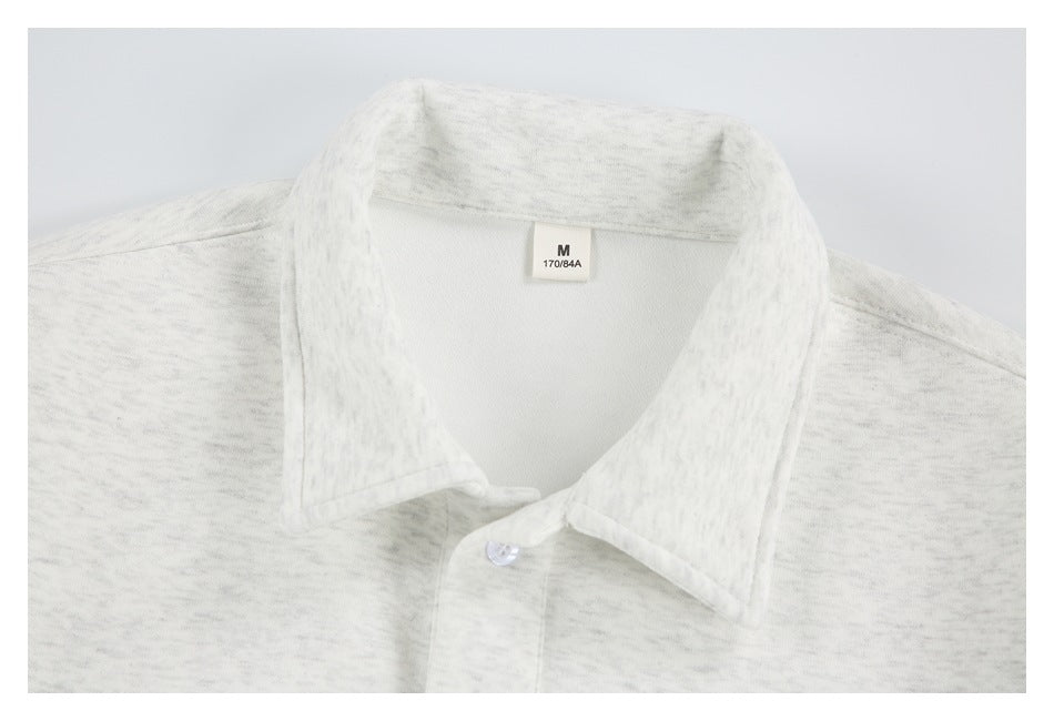Close-up of the collar and size tag on a light gray marled collared pullover.