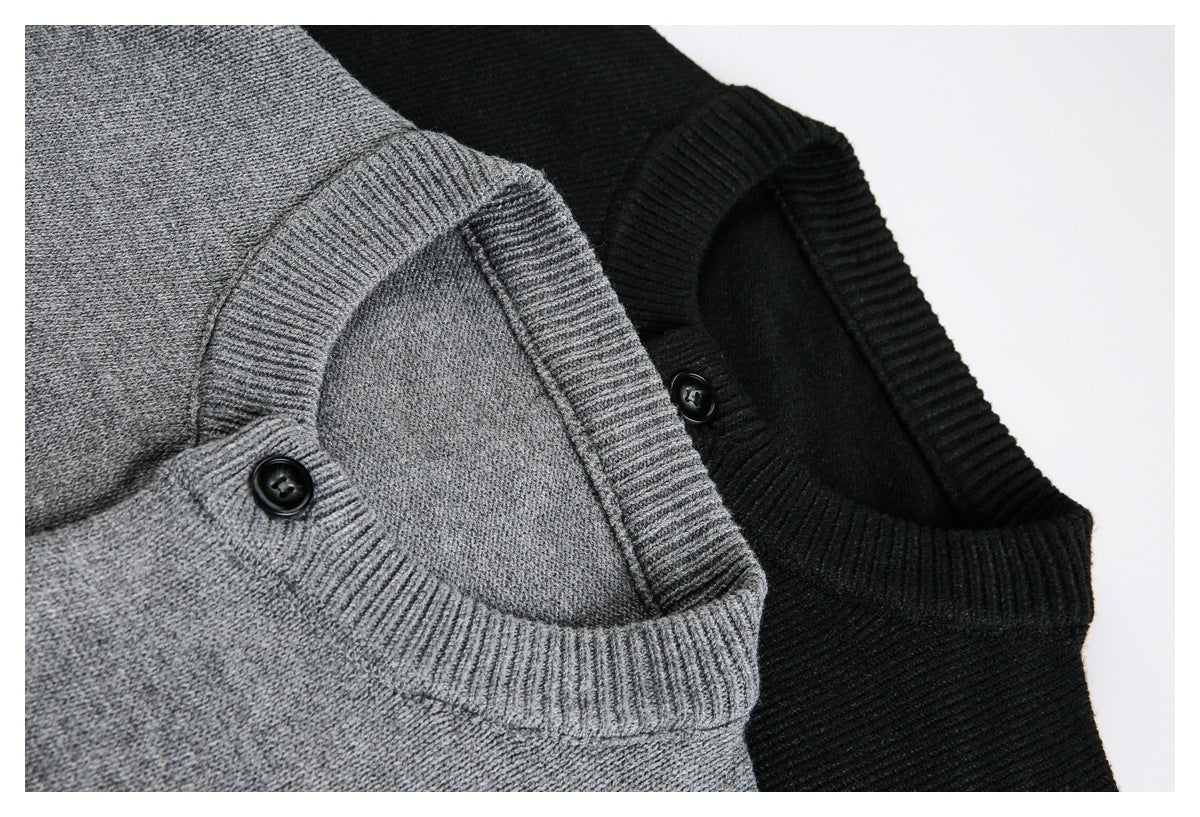 Close-up of gray and black cardigans showing ribbed necklines and button fastenings.