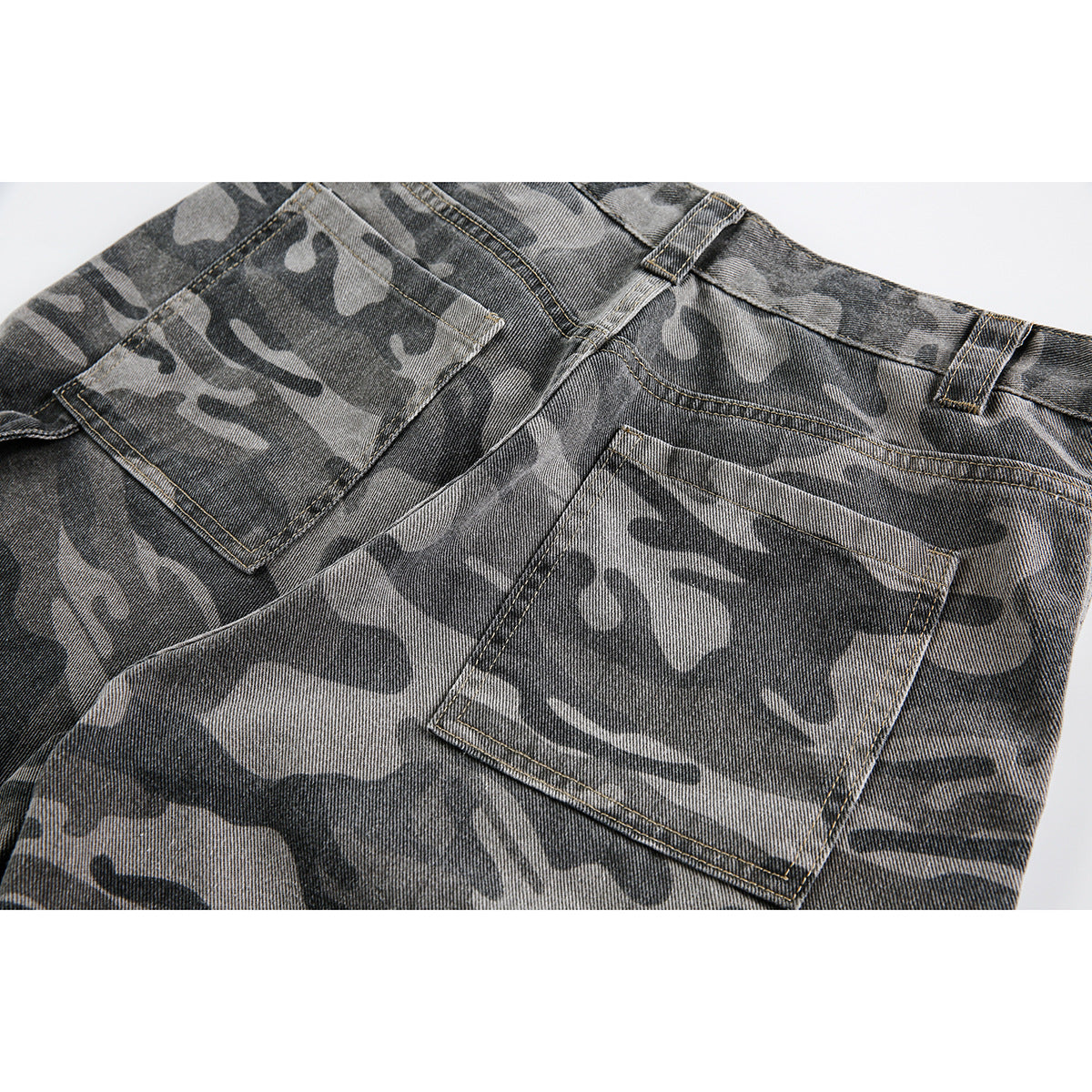 Close-up of the rear waistband and two patch pockets on gray camouflage shorts.