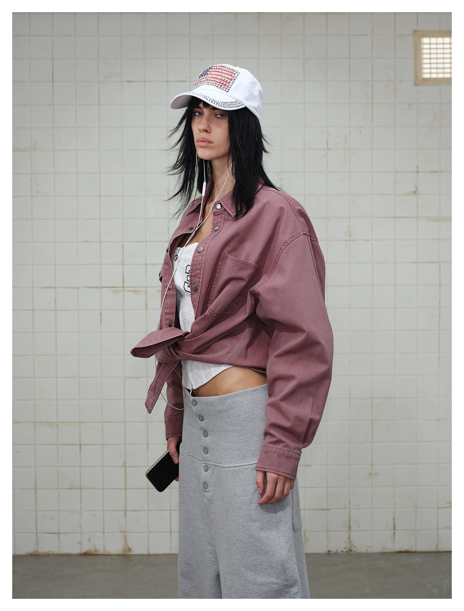 Model wearing a dusty mauve button-front overshirt tied at the waist, with a chest pocket and dropped shoulders.