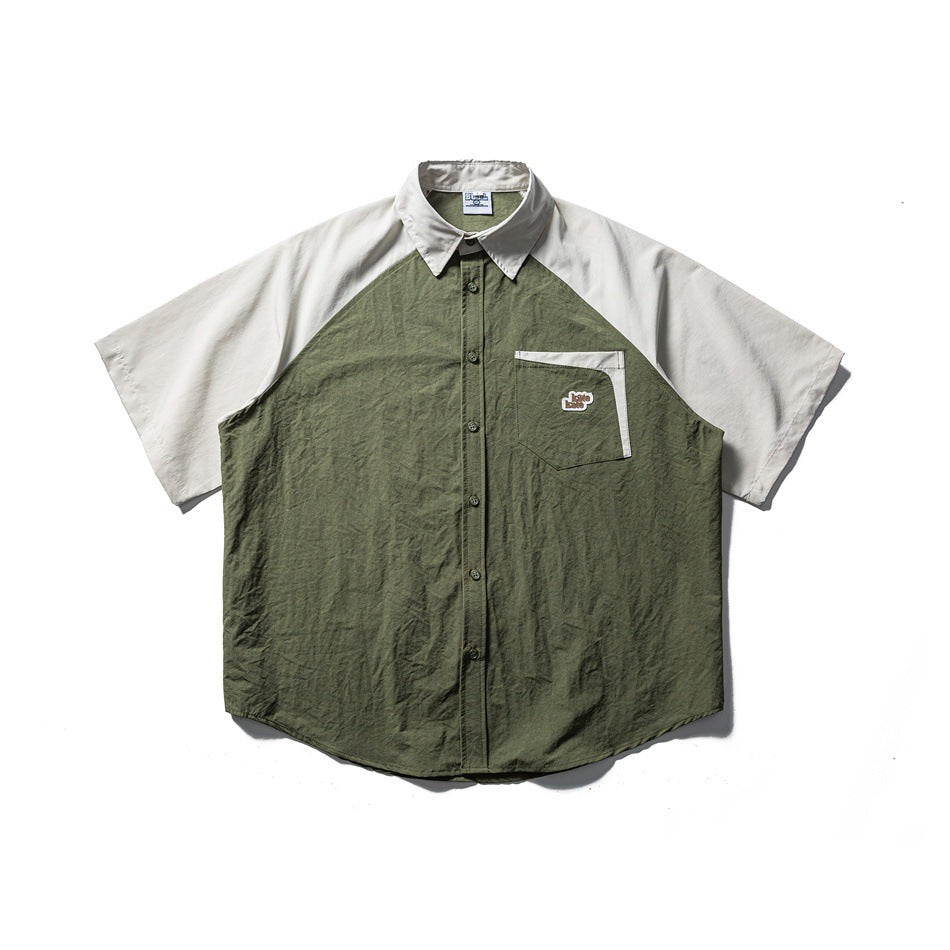 Short-sleeve raglan shirt with army green body, light gray-beige sleeves and collar, chest pocket, button front, flat lay
