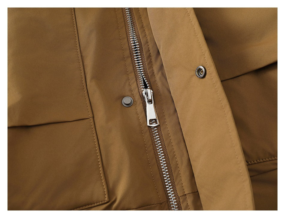 Close-up of a brown jacket with a silver front zipper, snap fasteners and a flap pocket.