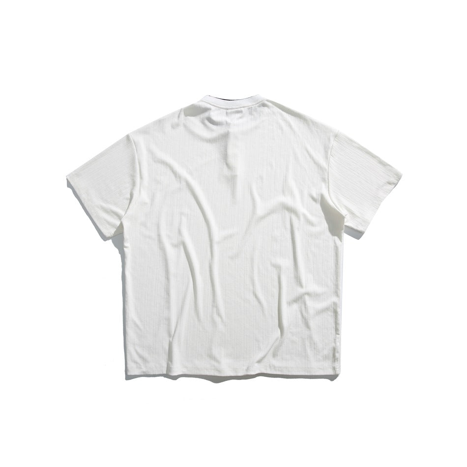 Back view of an off-white short-sleeve shirt with a band collar and ribbed texture.