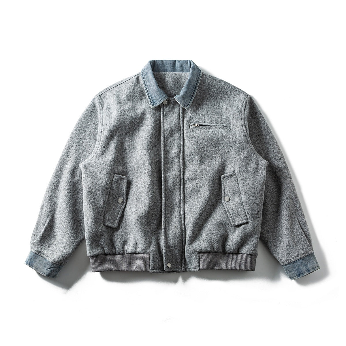 Light gray felt-like jacket with denim collar and cuffs, front zip, chest zip pocket, snap-flap pockets and ribbed hem