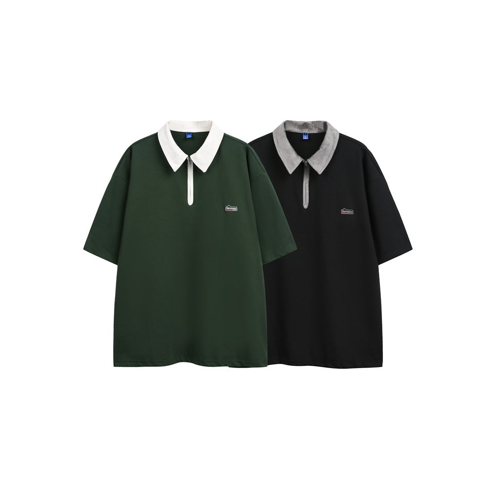 Front view of dark green and black short-sleeve polos with contrasting collars, short zips, and small chest logos.