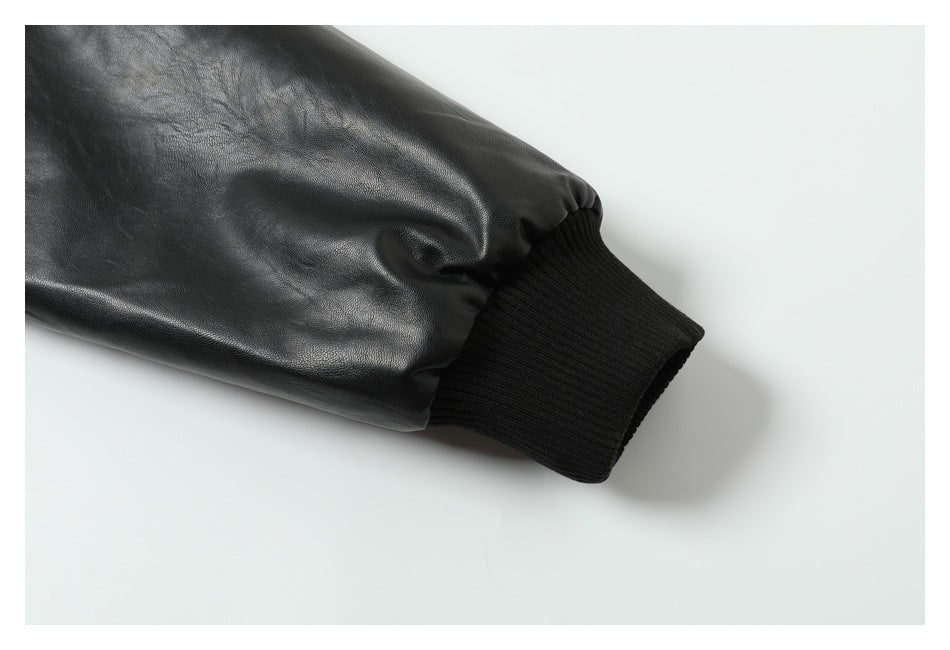 Close-up of a black jacket sleeve ending in a wide ribbed cuff.