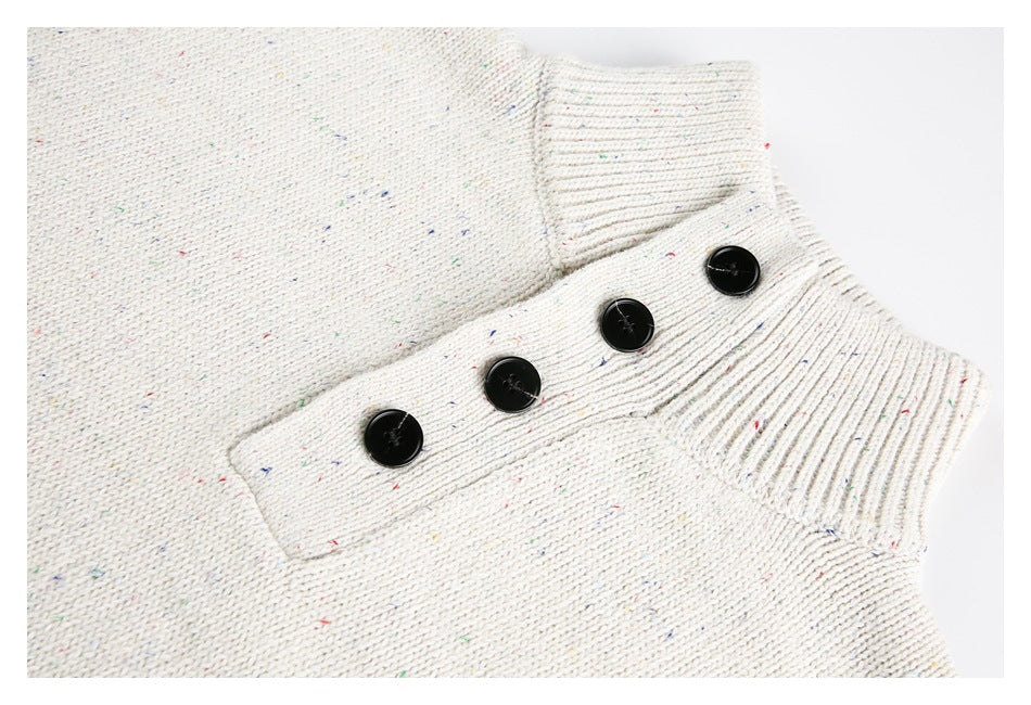 Cream flecked knit neckline detail with a ribbed collar and four black buttons.