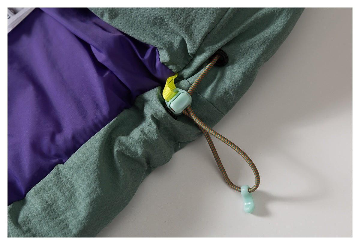 Close-up of the jacket's purple lining and adjustable hem cord with toggle.