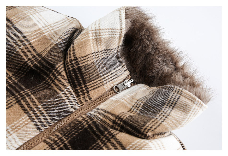 Close-up of a beige, brown and black plaid coat collar with faux-fur trim and a front zipper.