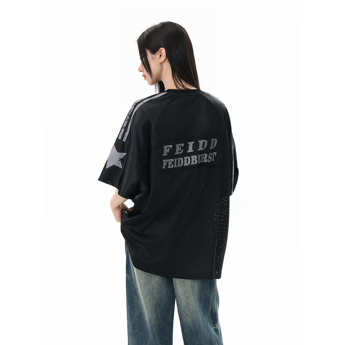 Model wearing an oversized black mesh jersey with gray lettering and sleeve stripes, shown from the back.