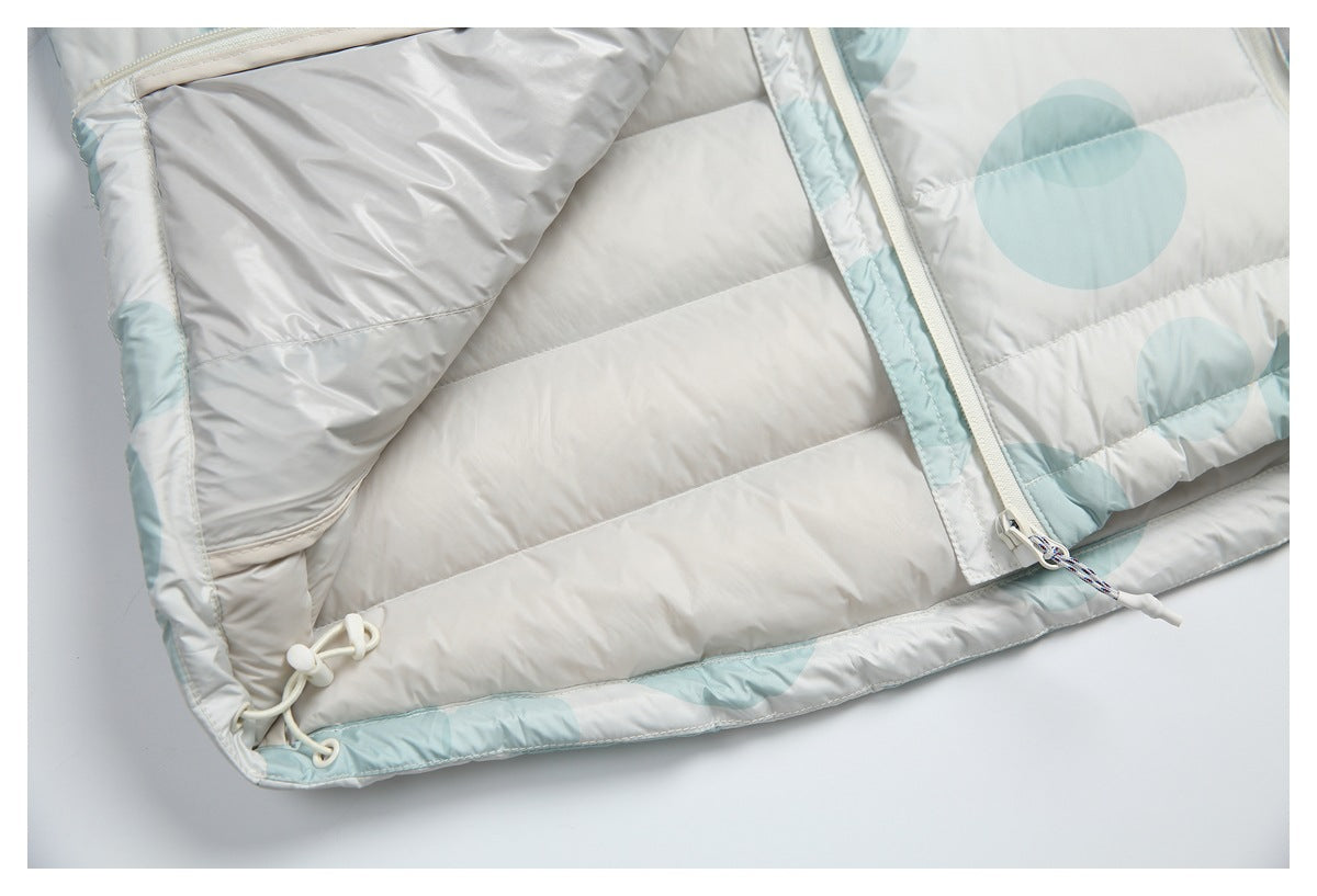 Close-up of a pale gray quilted puffer jacket with pale aqua accents, front zipper, and hem drawcord toggles.