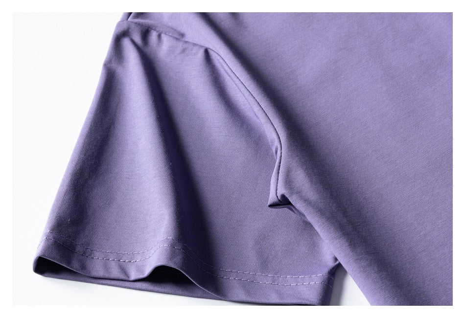 Close-up of a lavender-purple shirt sleeve and hem with visible double stitching.