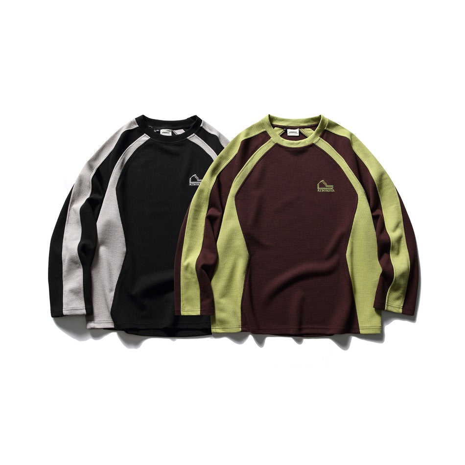 Two raglan sweatshirts displayed together: black with gray panels and burgundy with lime-green panels.