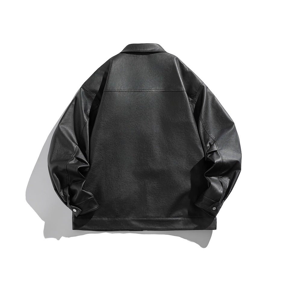 Back view of black faux leather jacket flat lay with collar, yoke seam and snap-button cuffs
