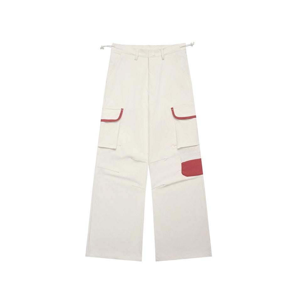 Off-white wide-leg cargo pants with red trim on flap pockets and a red patch pocket, shown flat from the front