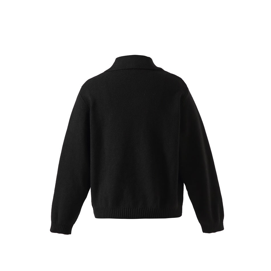 Back view of a plain black sweater with long sleeves, a short stand collar, and ribbed cuffs and hem.