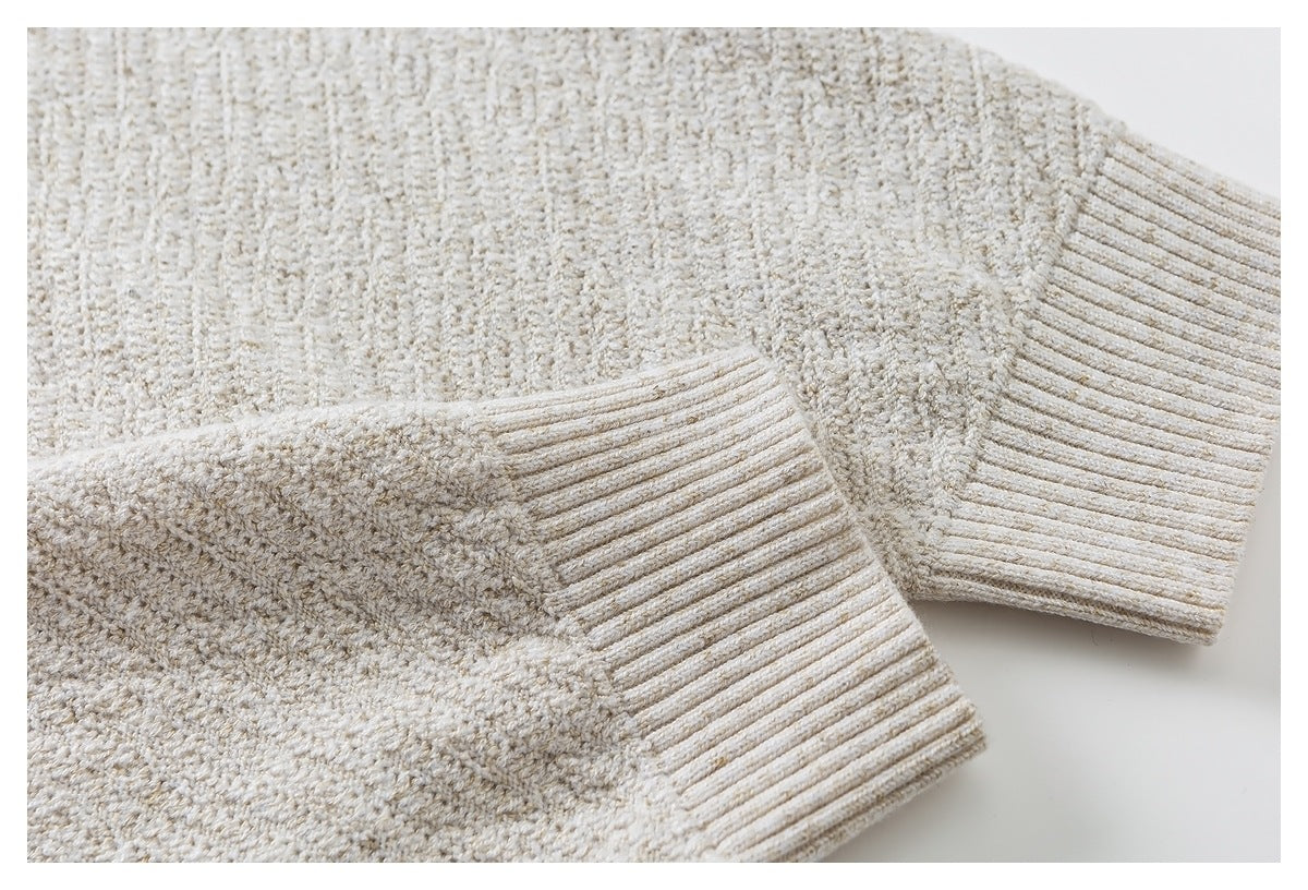 Close-up of cream textured knit sleeves and ribbed cuffs.