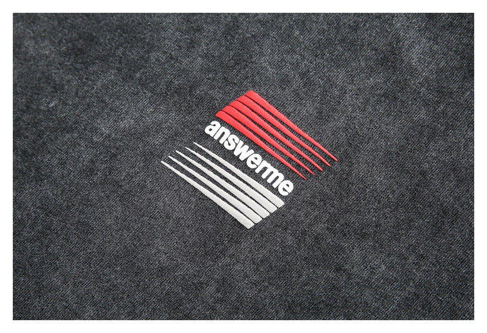 Red and white embroidered answerme graphic on charcoal fabric.