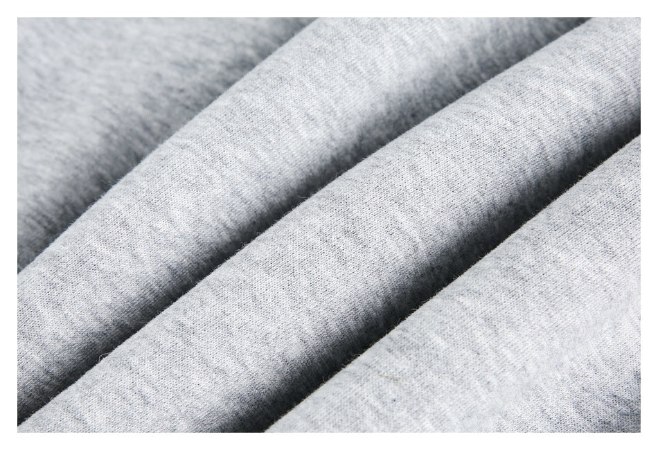 Macro view of the heathered light gray sweatshirt fabric.