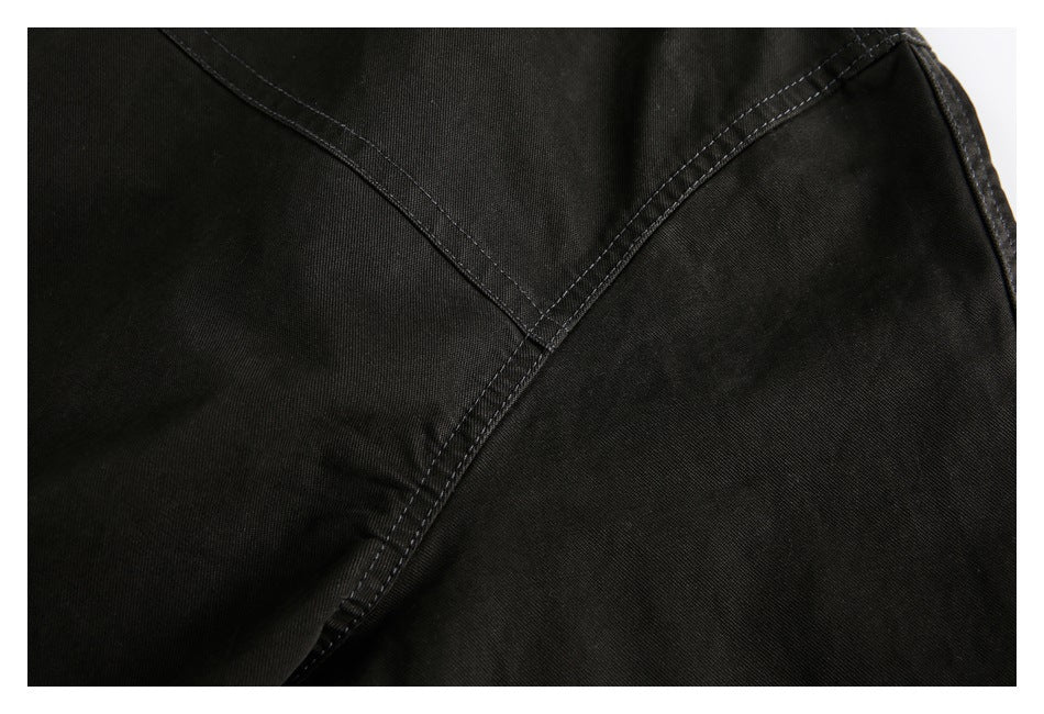 Close-up of intersecting stitched panels on the black jacket.
