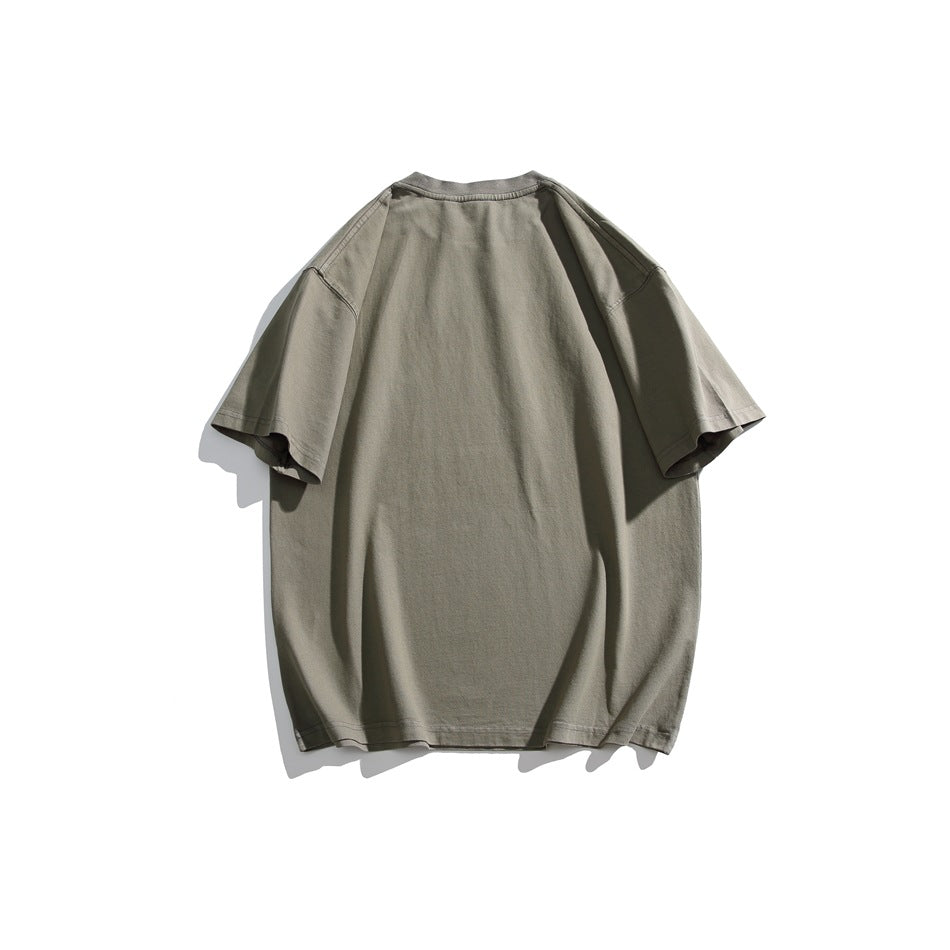 Back view of a plain oversized muted gray-green T-shirt with short sleeves.