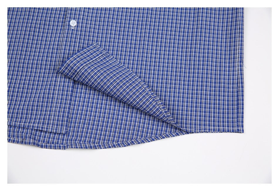 Close-up of the inside hem and seam of a blue-and-white checked shirt.