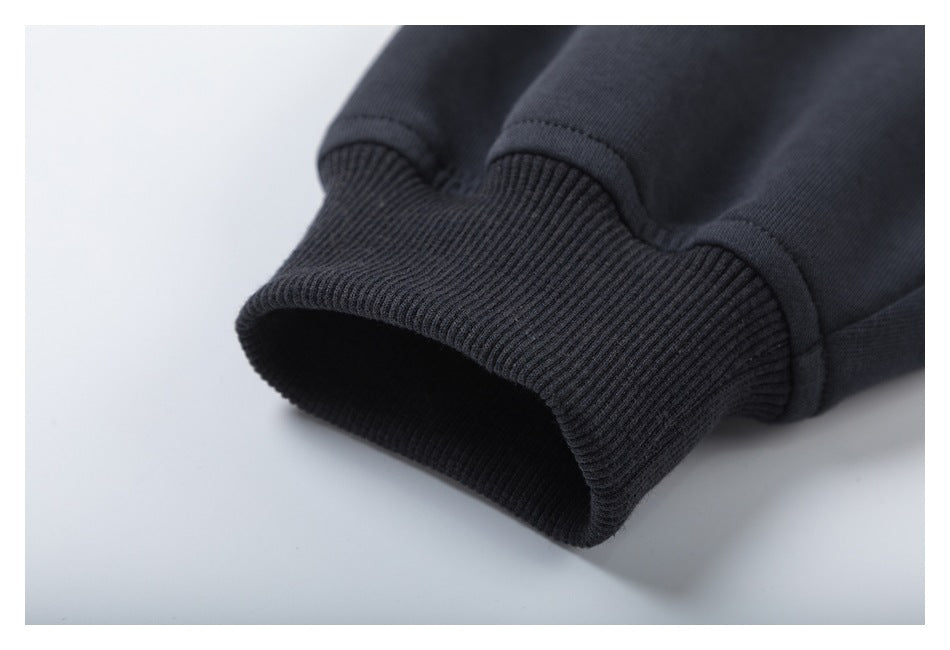 Close-up of a dark charcoal sleeve ending in a wide ribbed cuff.