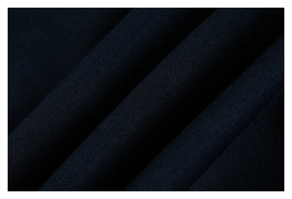 Close-up showing the dark navy garment fabric's fine knit texture and folds.