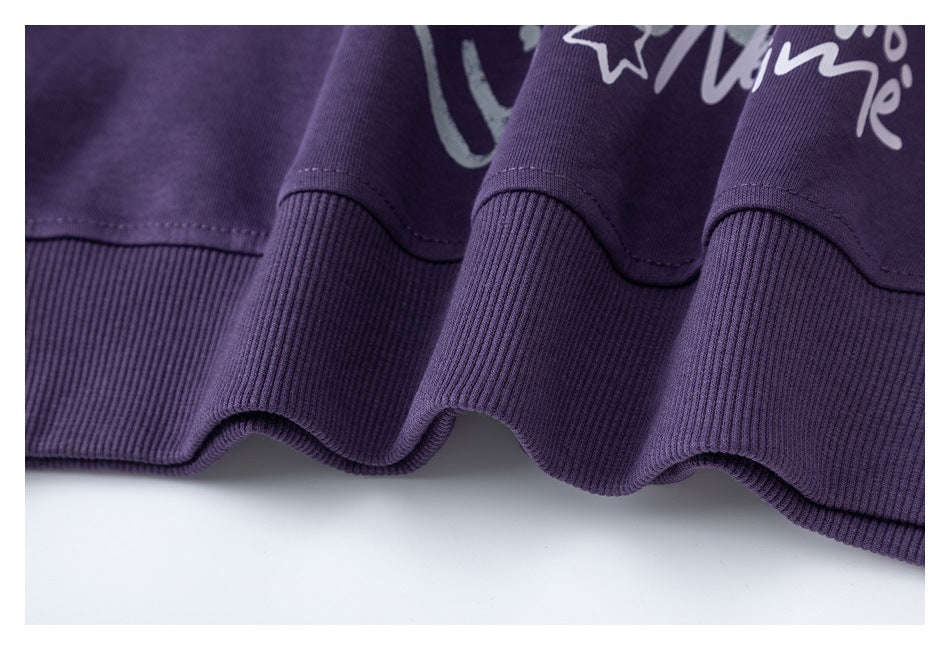 Close-up of the purple sweatshirt's ribbed bottom hem and stitching.