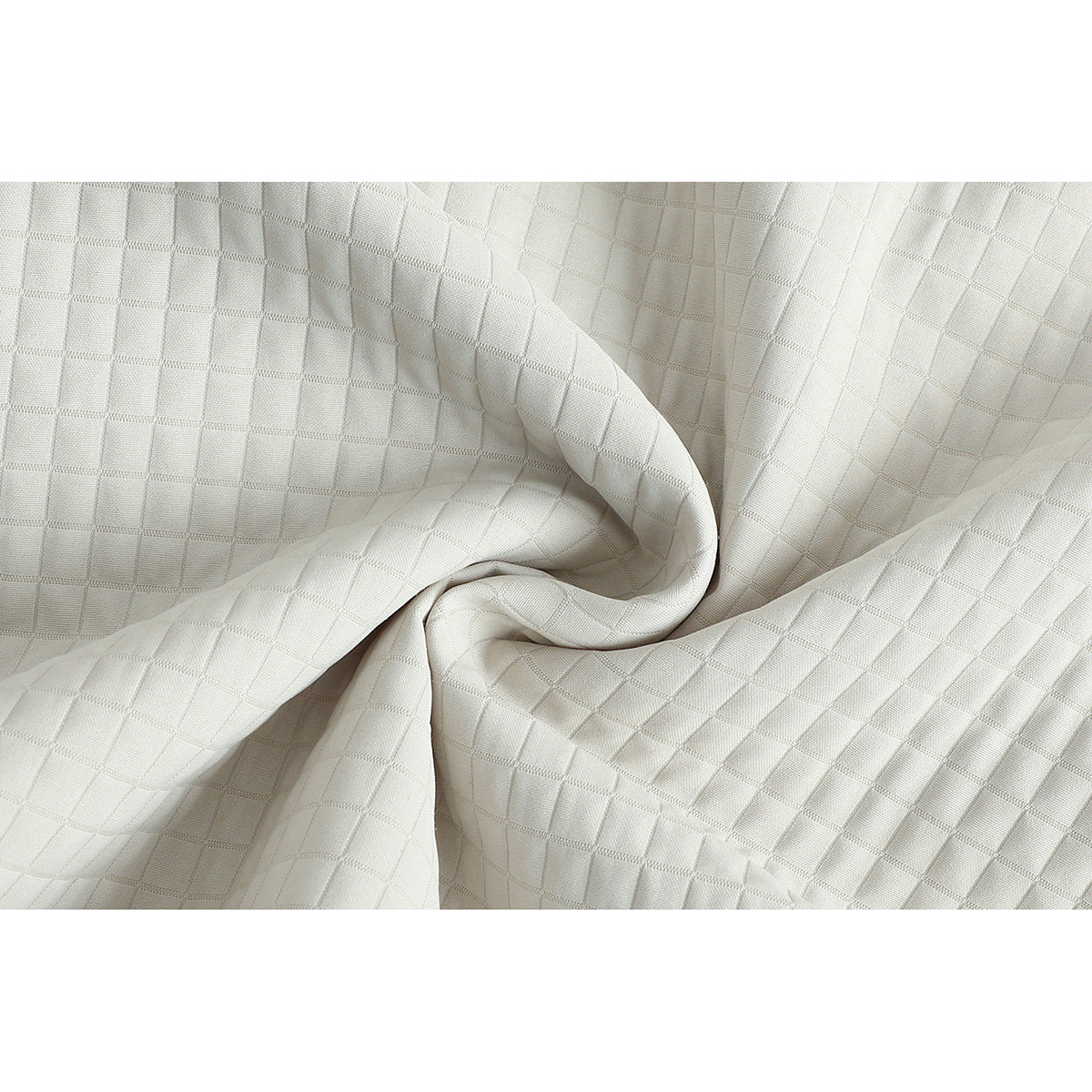 Close-up of ivory fabric with a raised square grid texture, draped into folds.