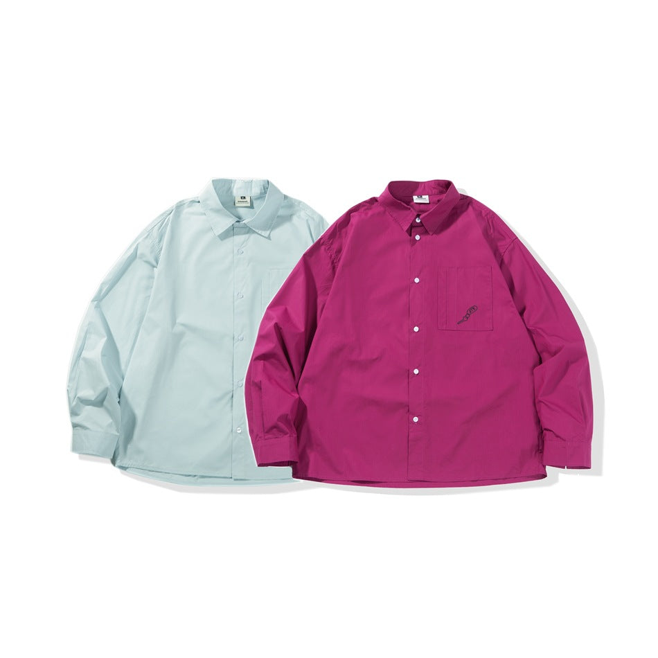 Two button-up shirts displayed side by side: pale blue and magenta, each with a chest pocket.