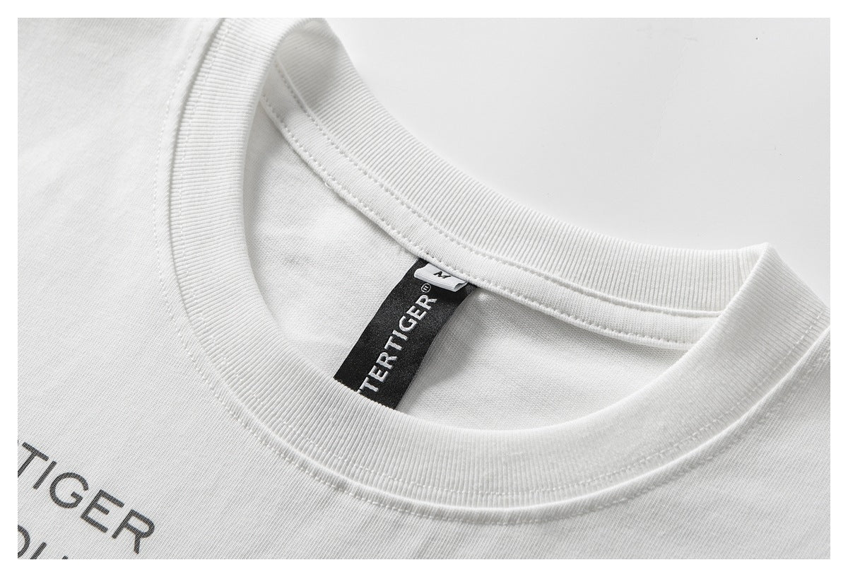 Close-up of a white T-shirt neckline, black Buttertiger neck label, and partial dark chest print.