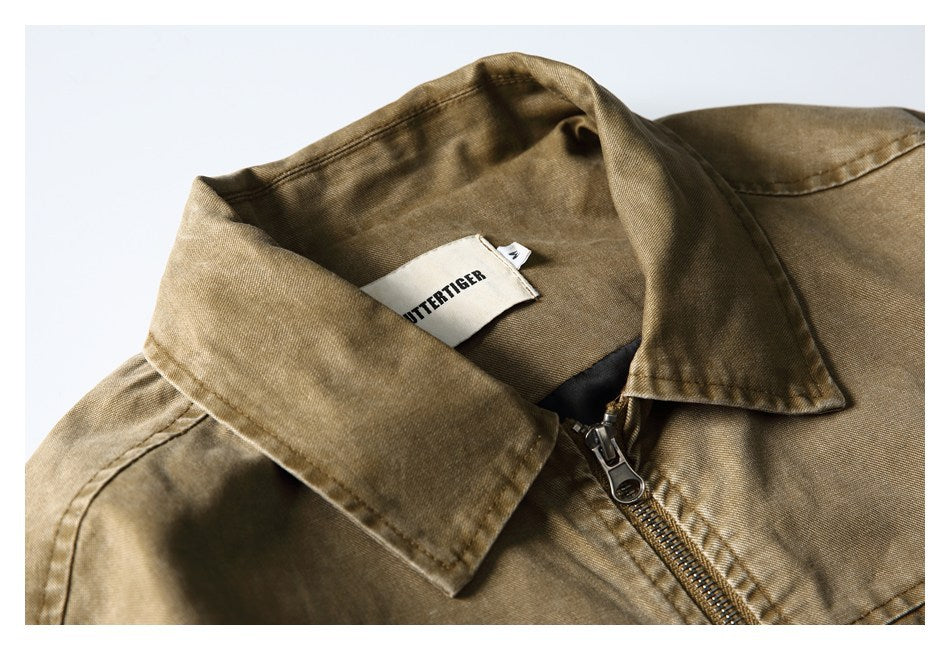 Close-up of a tan-brown jacket collar, zipper, and sewn neck label.
