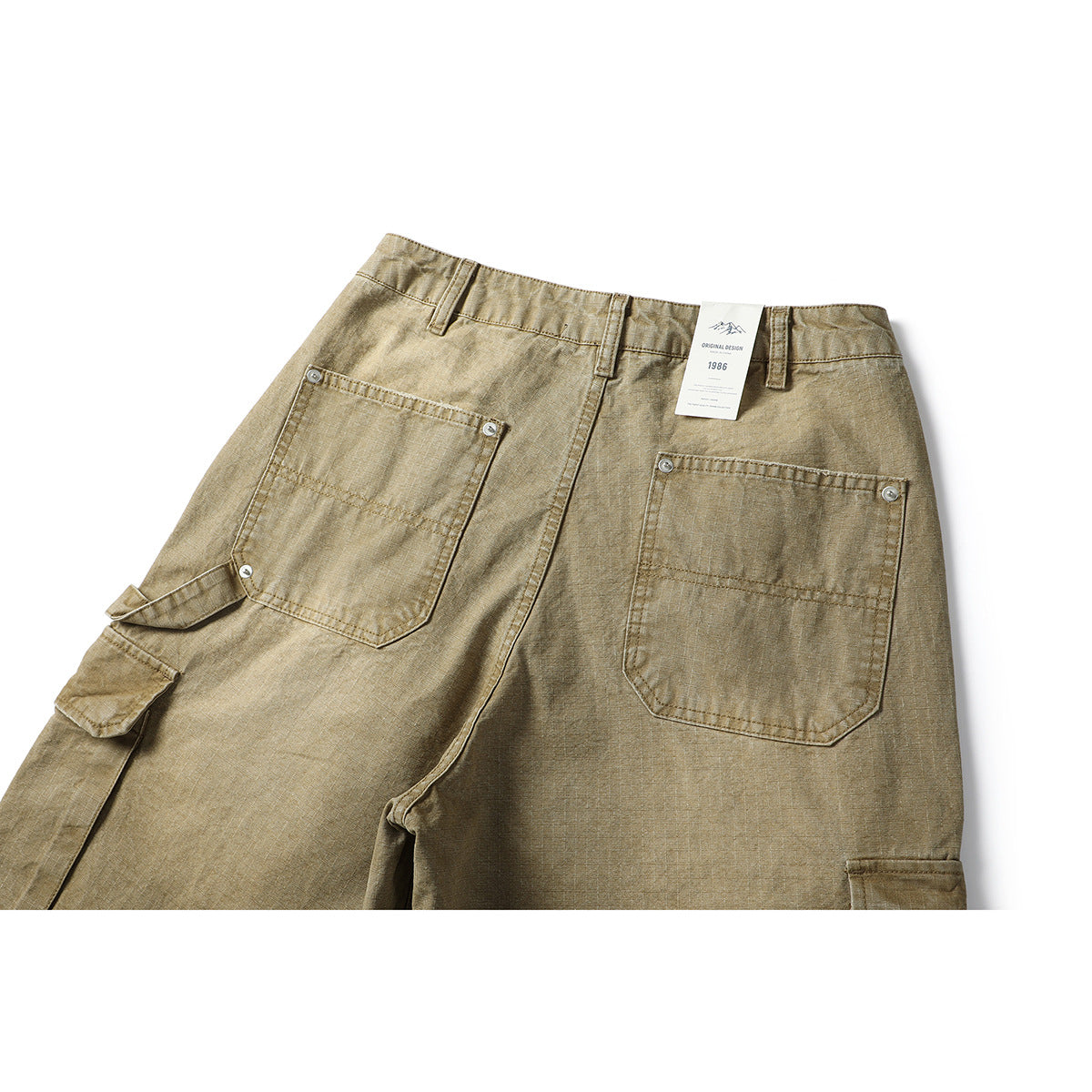 Upper back view of khaki cargo pants with two patch pockets, belt loops and a small hanging tag.