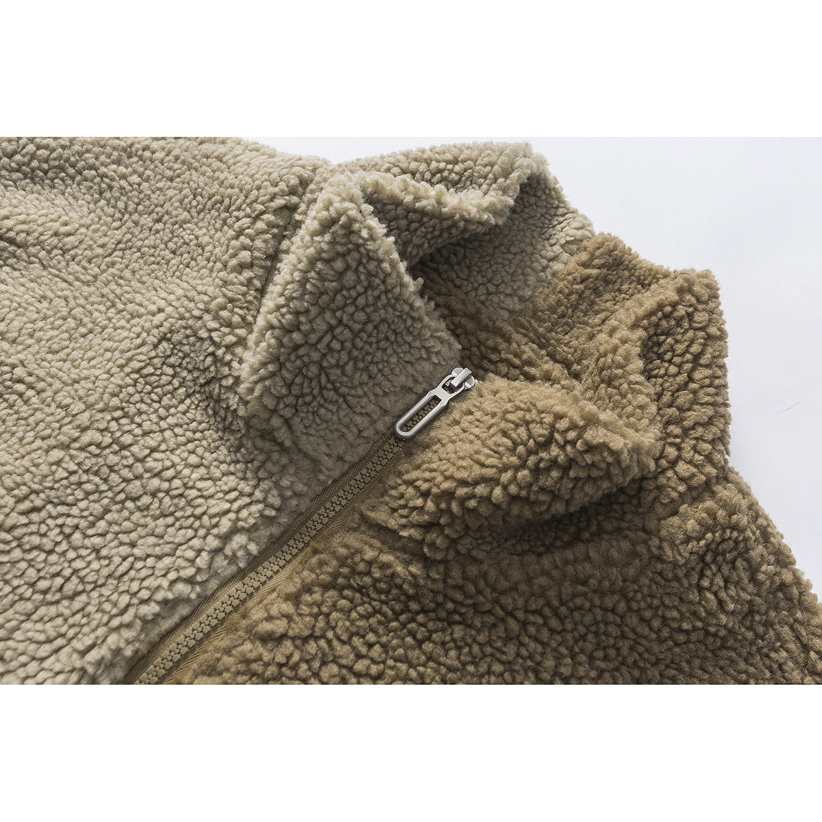 Close-up of a khaki textured fleece garment showing its raised collar and front zipper.