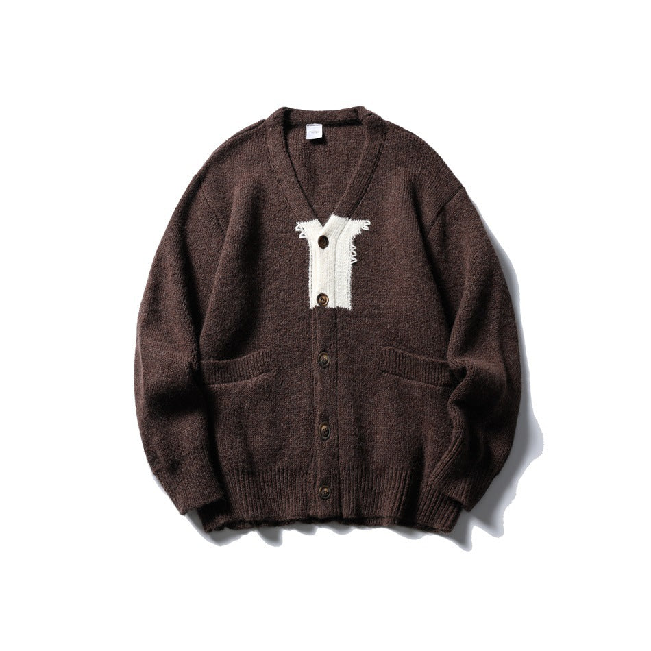 Brown knit V-neck cardigan with cream contrast chest panel, front buttons and two front pockets, flat lay