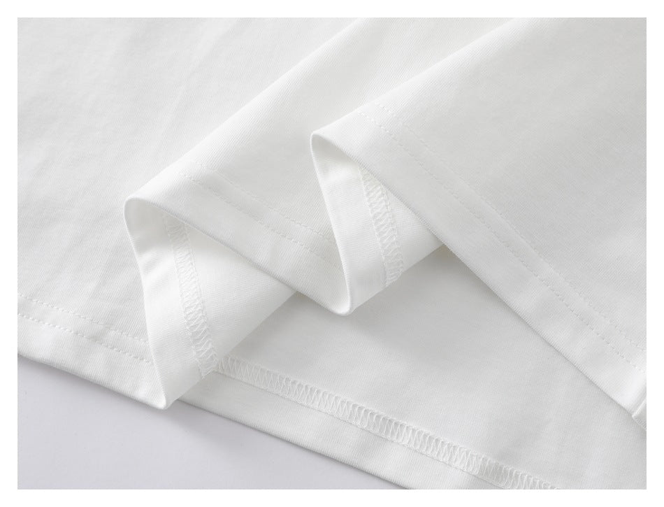 Close-up of a white T-shirt hem showing the stitching and inside seam.