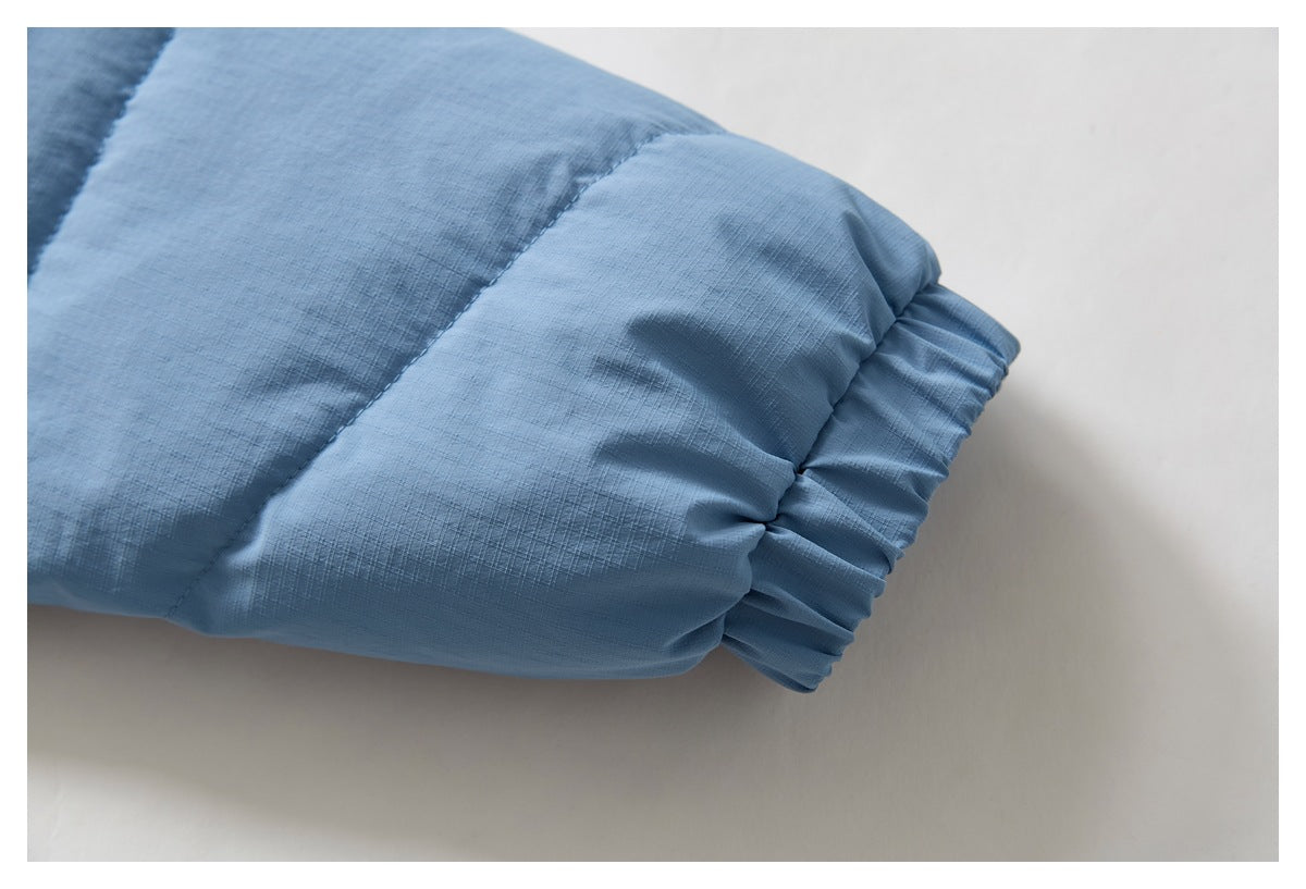 Close-up of a gathered elastic cuff on a light blue jacket sleeve.