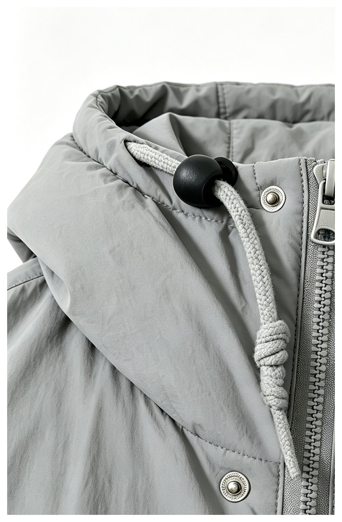 Close-up of the light gray jacket's hood drawcord, black toggle, snap fasteners and front zipper.