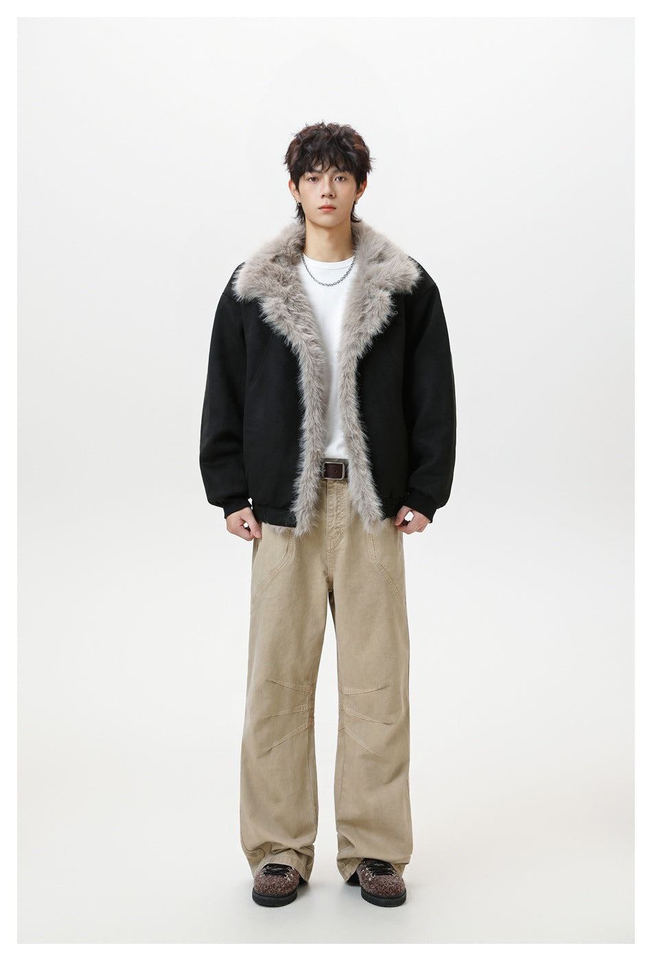 Full-length model wearing a black jacket with a wide plush light gray fur collar and front trim.