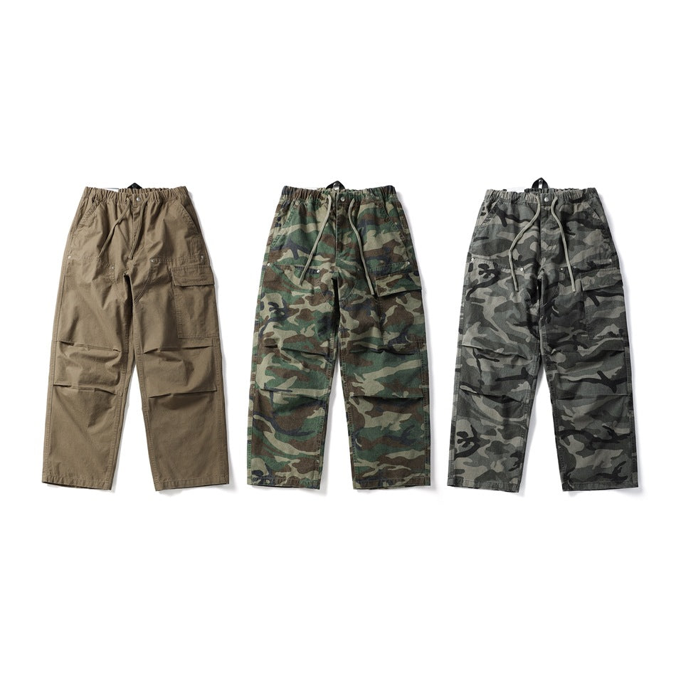 Three pairs of cargo pants shown together: solid tan, green camouflage, and gray camouflage.